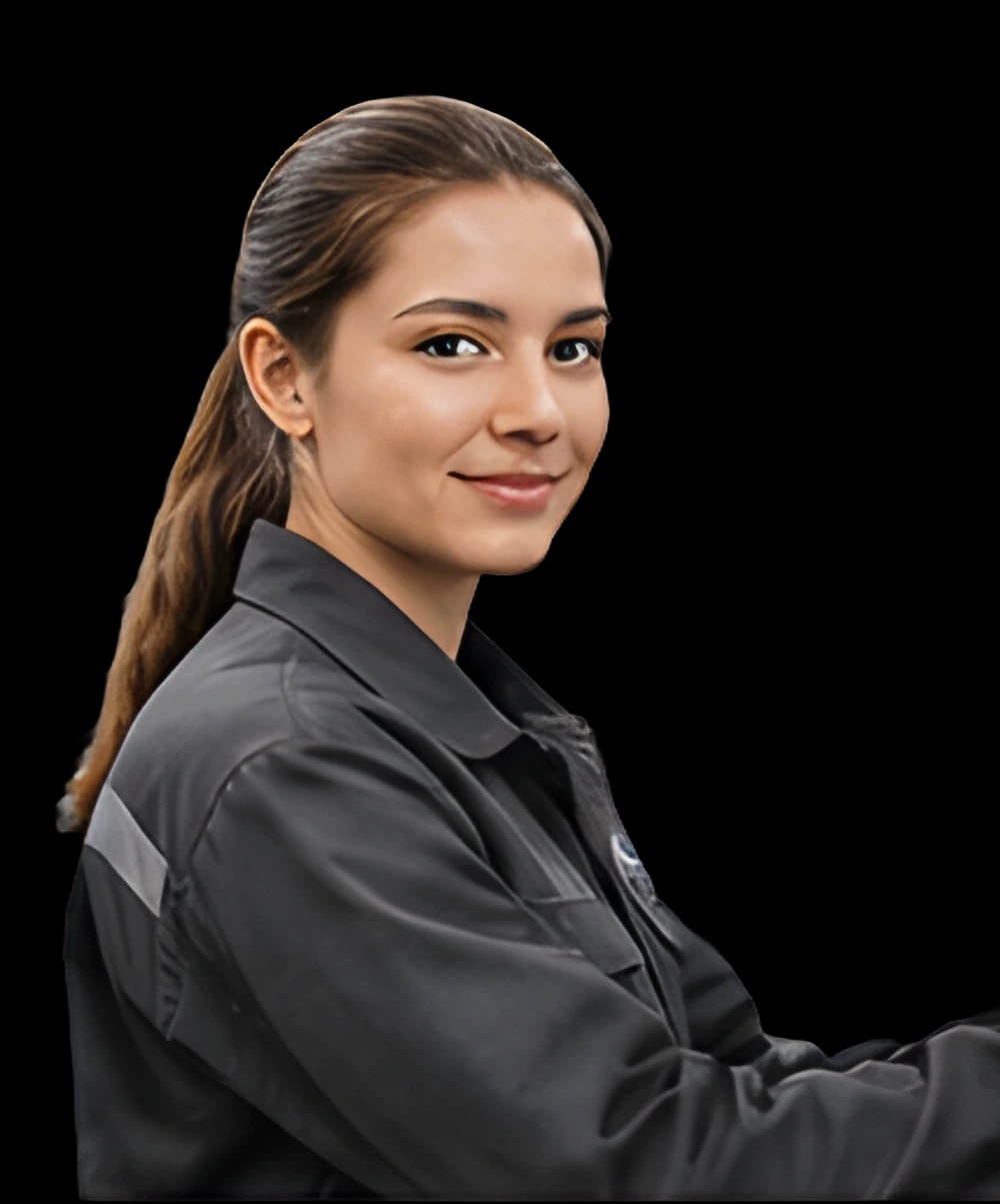 A smiling technician in a dark work jacket, reaching out to a control panel.